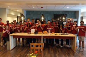 A group of students holding their hands in the shape of Ts